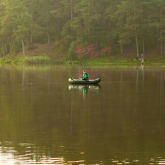 The fishermen on the boat in the fog.