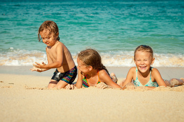 happy kids playing on beach at the day time