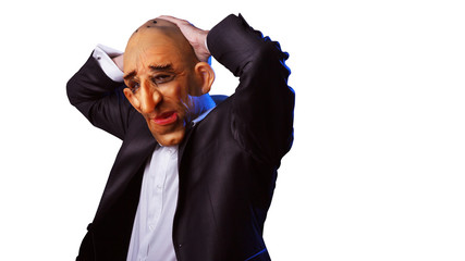 Scary man in suit with mask holding his head