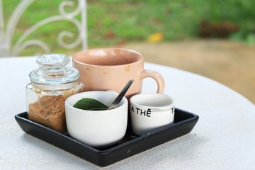 Cup of coffee and sugar on the table.