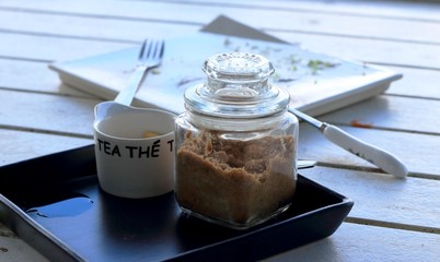 Cup of coffee and sugar on the table.