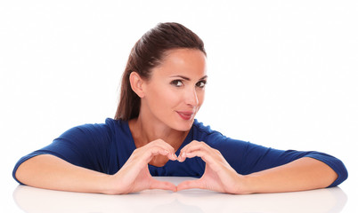 Smiling woman making a love sign