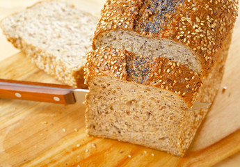 Cutted rye bread loaf on wooden table