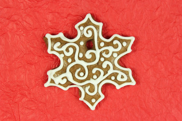 christmas snowflake shape gingerbread on red background