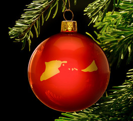 Red bauble with the golden shape of Midway Islands hanging on a