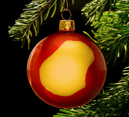 Red bauble with the golden shape of Nauru hanging on a christmas