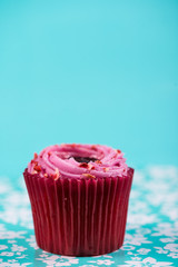 red cup cake on blue background