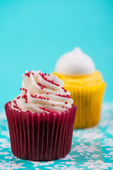 red and yellow cup cake on blue background