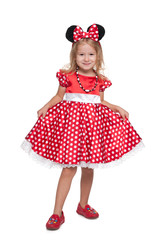 Little girl stands against the white