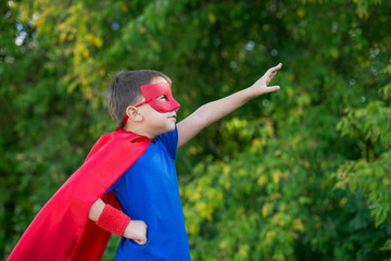 Superhero standing sideways and calling on forward