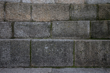 Natural stones are folded in wall. Background.