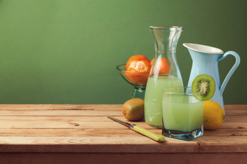 Fruit juice on wooden table with copy space