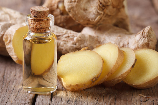 ginger oil in a glass bottle close-up, horizontal