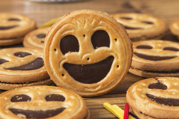 Round smiling chocolate cookies with colour confeti