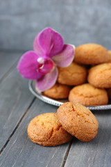 Almond cookies with orchid flower on rustic wooden table