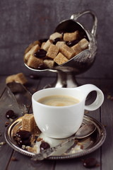 Cup of espresso, sugar cubes and chocolate candy