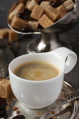 Cup of espresso, sugar cubes and chocolate candy