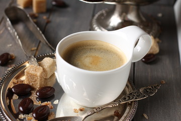 Cup of espresso, sugar cubes and chocolate candy