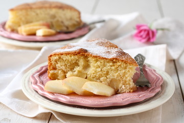Slice of homemade apple sponge cake on pink plate