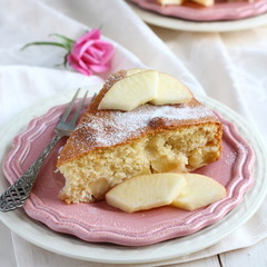Slice of homemade apple sponge cake on pink plate