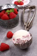 Ice cream scoop with berry ice cream and raspberry