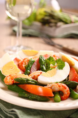 Fresh salad with asparagus, eggs, shrimp and tomatoes