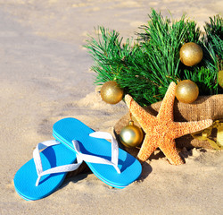 Christmas tree with christmas balls, slippers and starfish on th