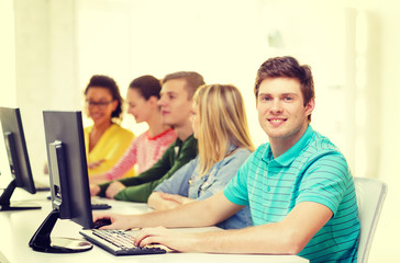 male student with classmates in computer class
