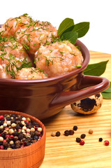 Stewed delicious meatballs in ceramic dish, quail egg and pepper