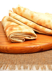 Lavash, tortilla wrap Bread on the cutting board isolated