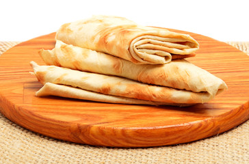 Lavash, tortilla wrap Bread on cutting board isolated on white