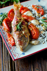 Red mullet baked with tomato, garlic and rosemary with a garnish