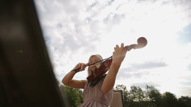 Musical quartet. Three violinists and cellist playing music.