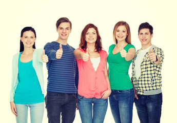 group of smiling students showing thumbs up