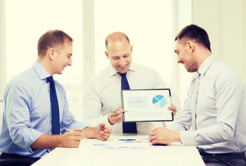 smiling businessmen with papers in office