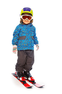 Boy stands wearing mountain skies isolate on white