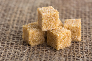 cubes of brown sugar on jute bags