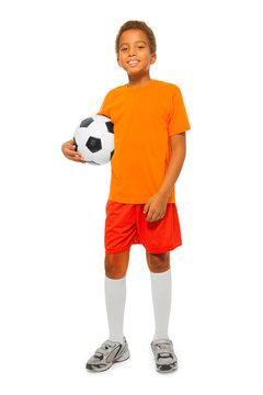 Little African boy holding soccer ball isolated