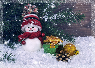 Christmas background with a small snowman on the background of t