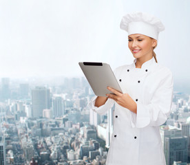 smiling female chef with tablet pc computer