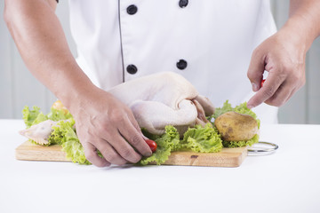 Chef prepared cooking raw chicken