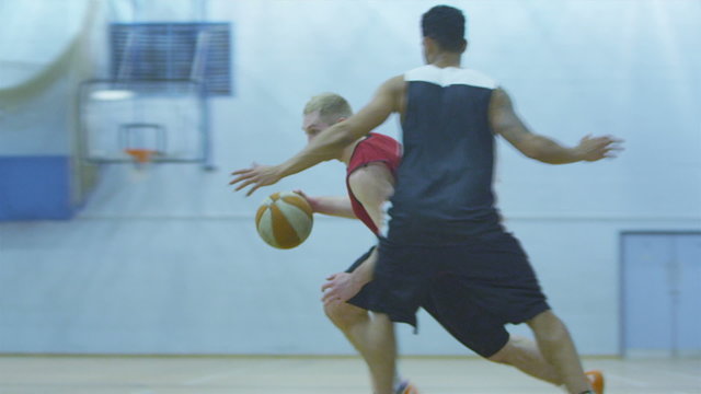 Basketball player attacking and dunking in slow motion
