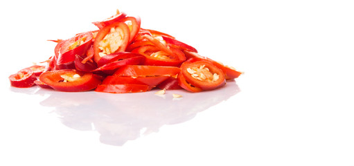 Cut slices of red chili pepper on white background