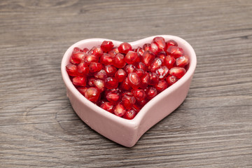 Juicy pomegranate isolated on wood background