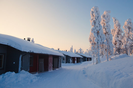Beautiful lapland snowy winter landscape with cottage cabin vill