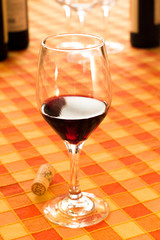 Glass of red wine in the rustic tablecloth