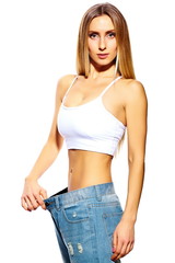 beautiful sport young fitness woman in big jeans