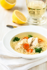 Fototapeta na wymiar Chicken soup with vegetables and orzo