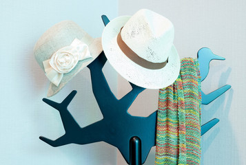 Bright colored scarf with hat hanging on a rack. in a dressing r