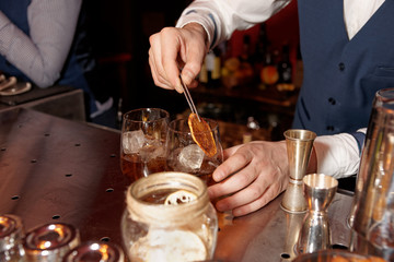 Barman works at bar counter